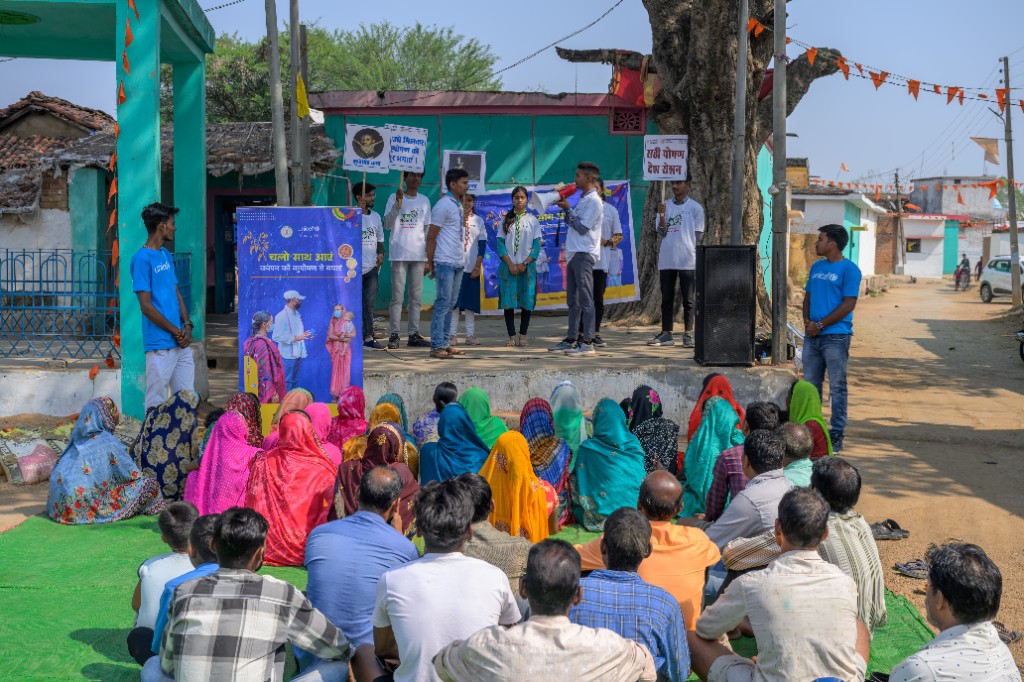 Team members talking with community members in a rural setting
